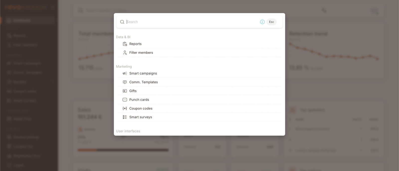 La superposición de la paleta de navegación rápida. El encabezado dice "Search" con un atajo Esc. Debajo: sección Data & BI (Reports, Filter members), sección Marketing (Smart campaigns, Comm. Templates, Gifts, Punch cards, Coupon codes, Smart surveys), sección User Interfaces (cortada por debajo del fold).